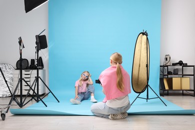 Photo of Photographer working with model in professional photo studio