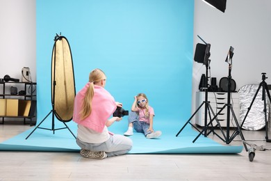 Photo of Photographer working with model in professional photo studio
