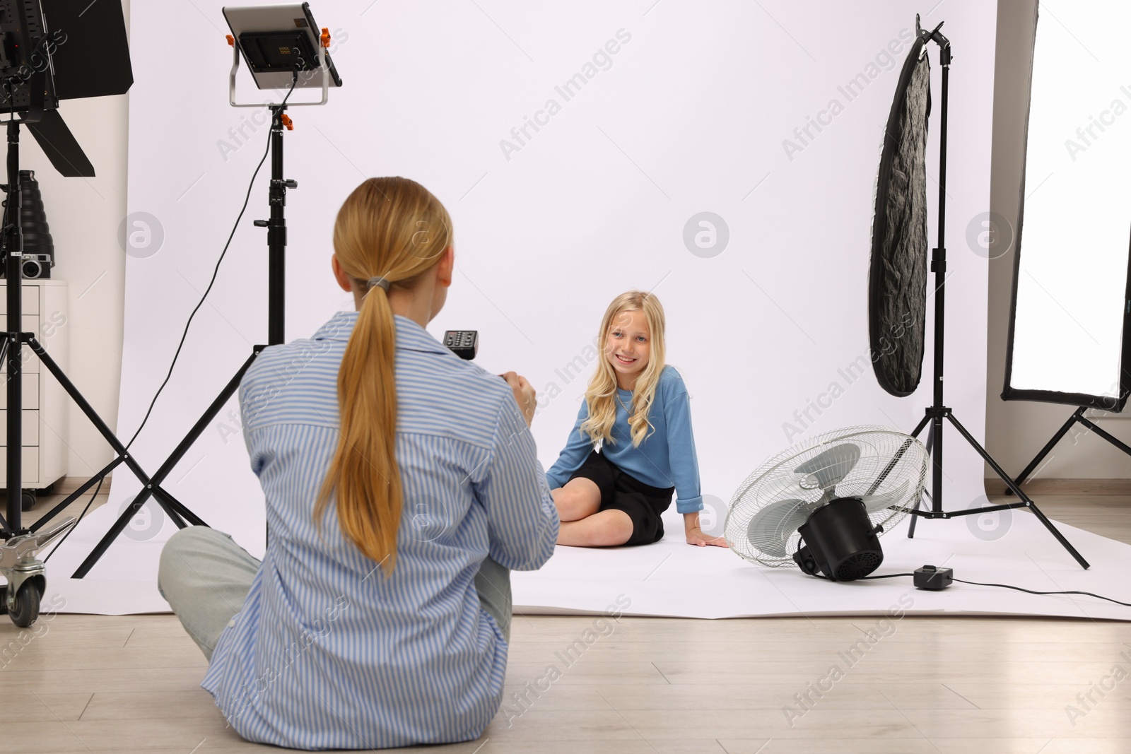Photo of Photographer working with model in professional photo studio