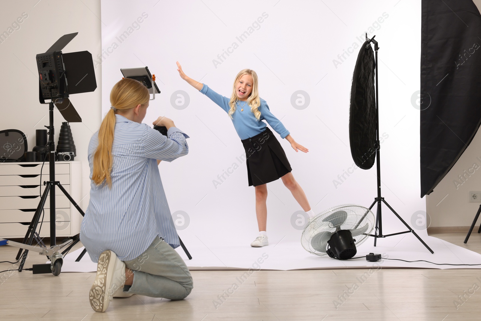 Photo of Photographer working with model in professional photo studio