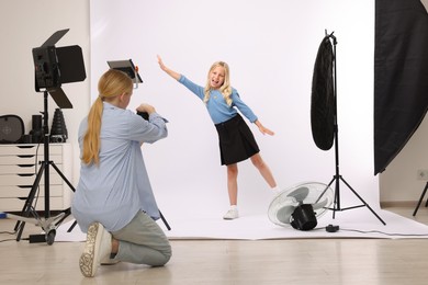 Photo of Photographer working with model in professional photo studio