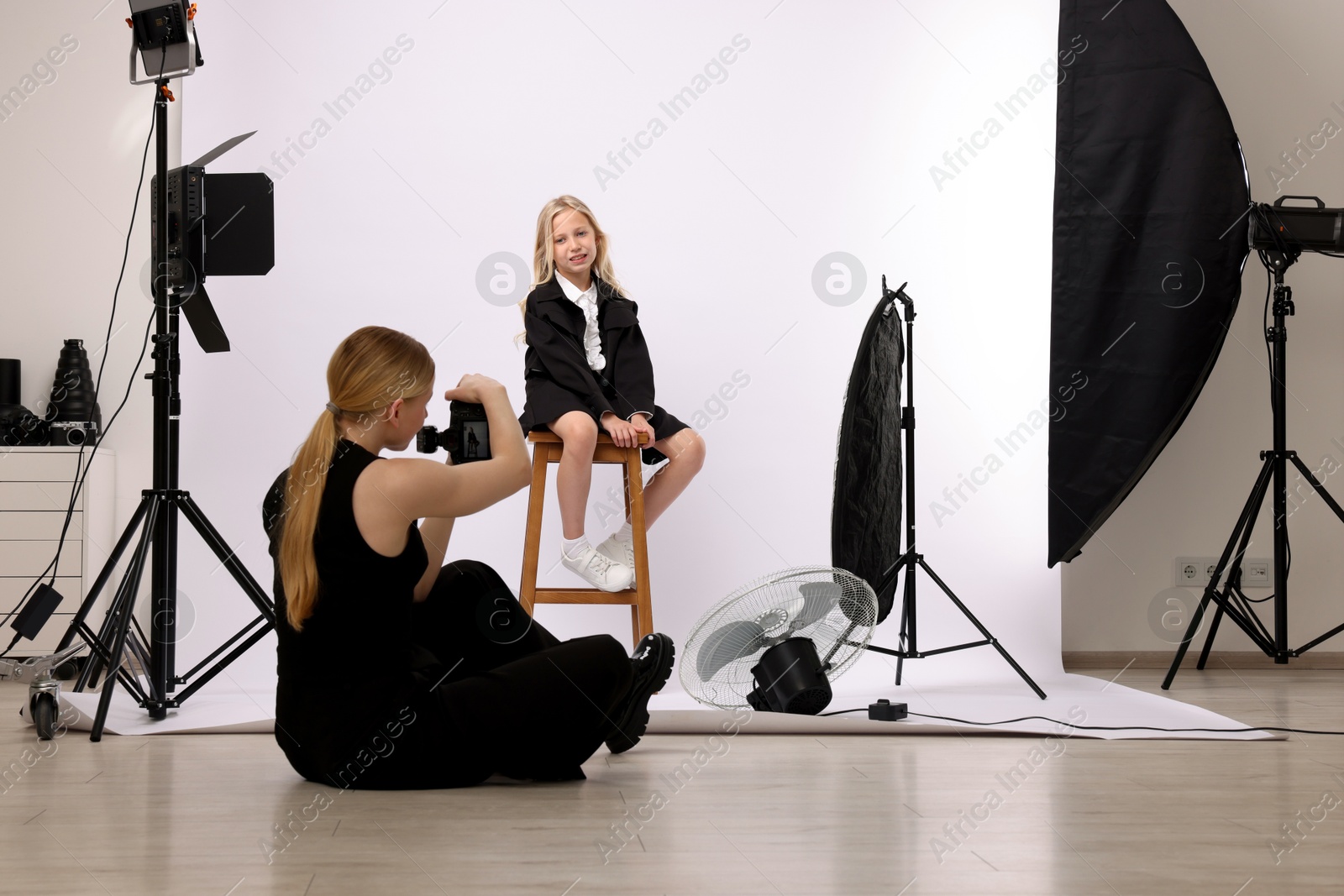 Photo of Photographer working with model in professional photo studio