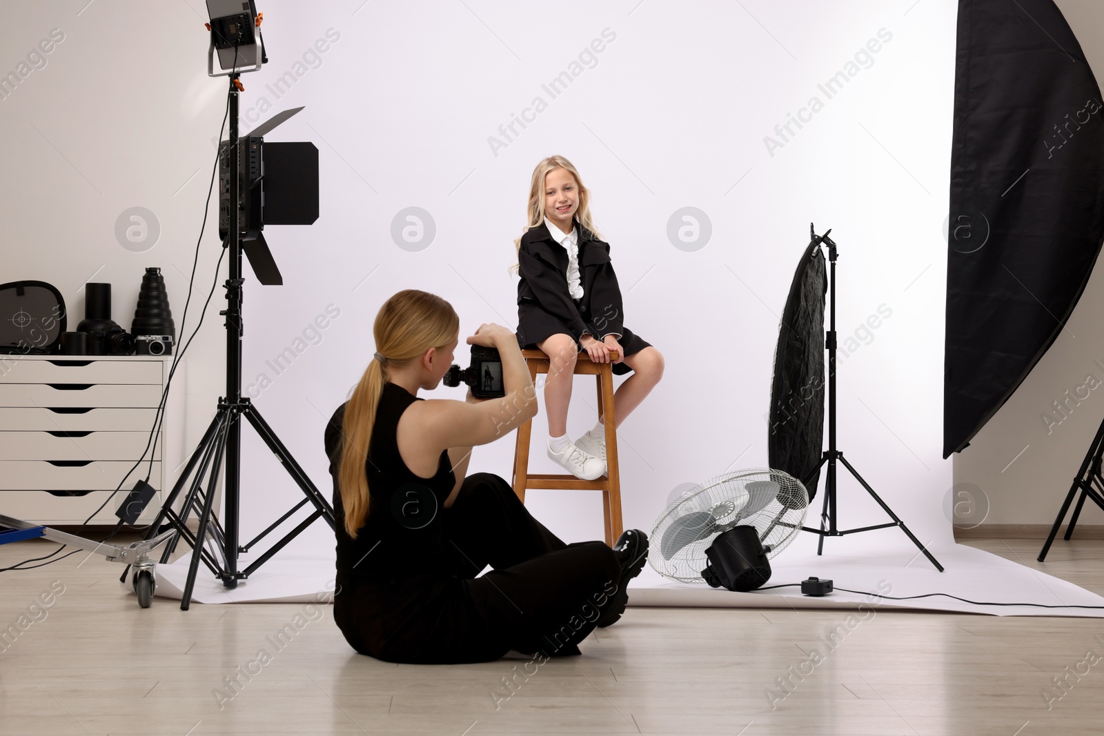 Photo of Photographer working with model in professional photo studio