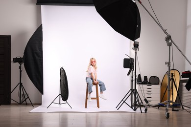 Photo of Little girl on white background in photo studio with professional equipment
