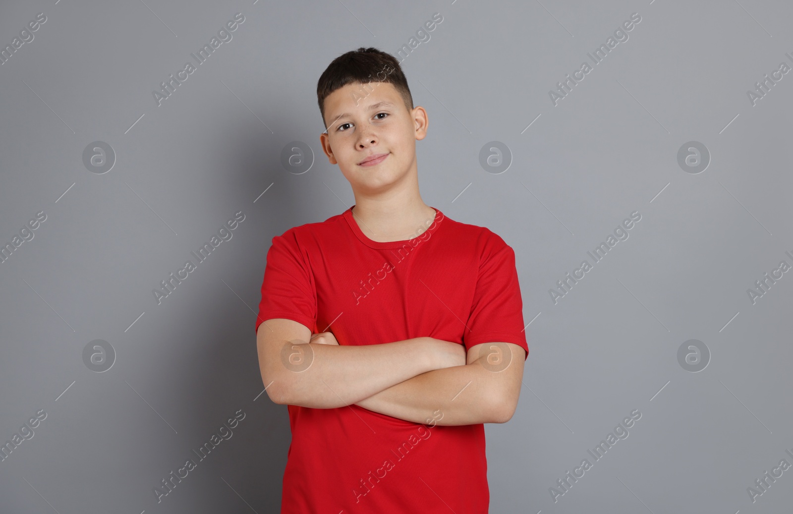 Portrait of teenage boy on grey background Photo of Portrait of teenage boy on grey background