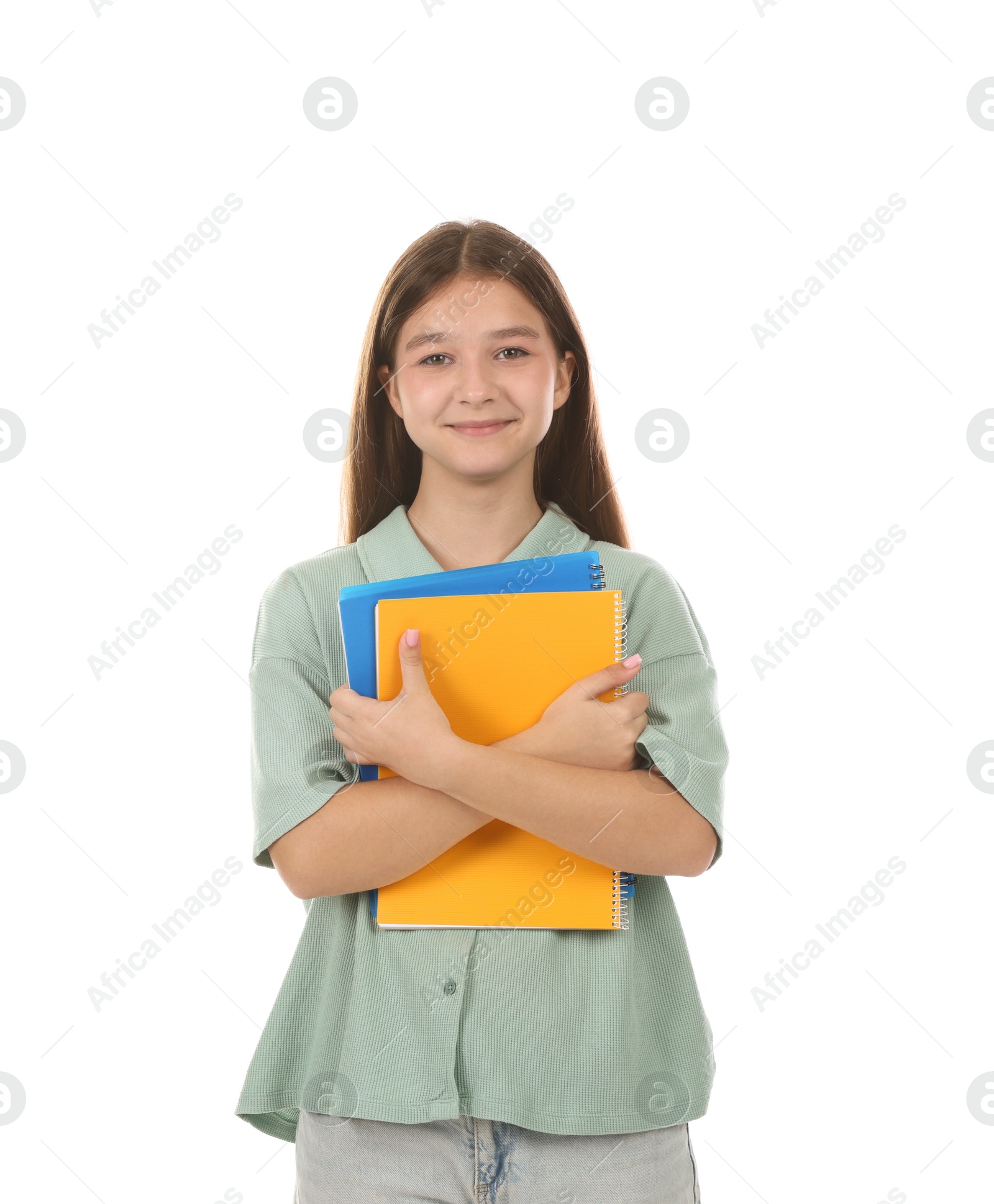 Teenage girl with notebooks on white background Photo of Teenage girl with notebooks on white background