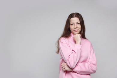 Photo of Portrait of teenage girl on light grey background, space for text
