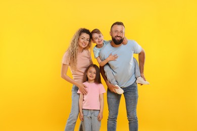 Photo of Portrait of happy family on yellow background