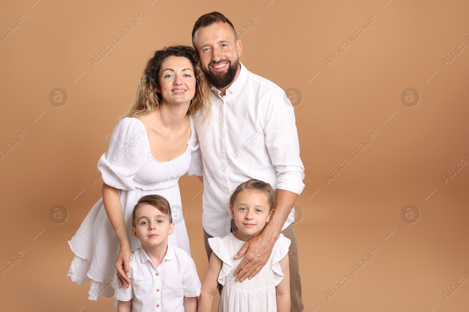 Photo of Portrait of happy family on beige background