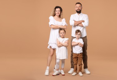 Photo of Happy family posing on beige background. Space for text