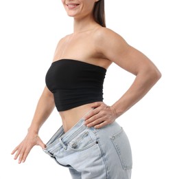 Photo of Fit woman wearing old jeans after weight loss on white background, closeup