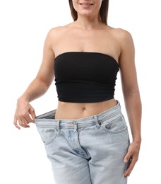 Photo of Fit woman wearing old jeans after weight loss on white background, closeup