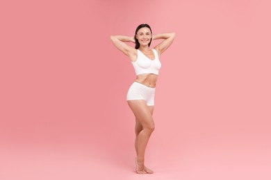 Photo of Fit woman with perfect body on pink background