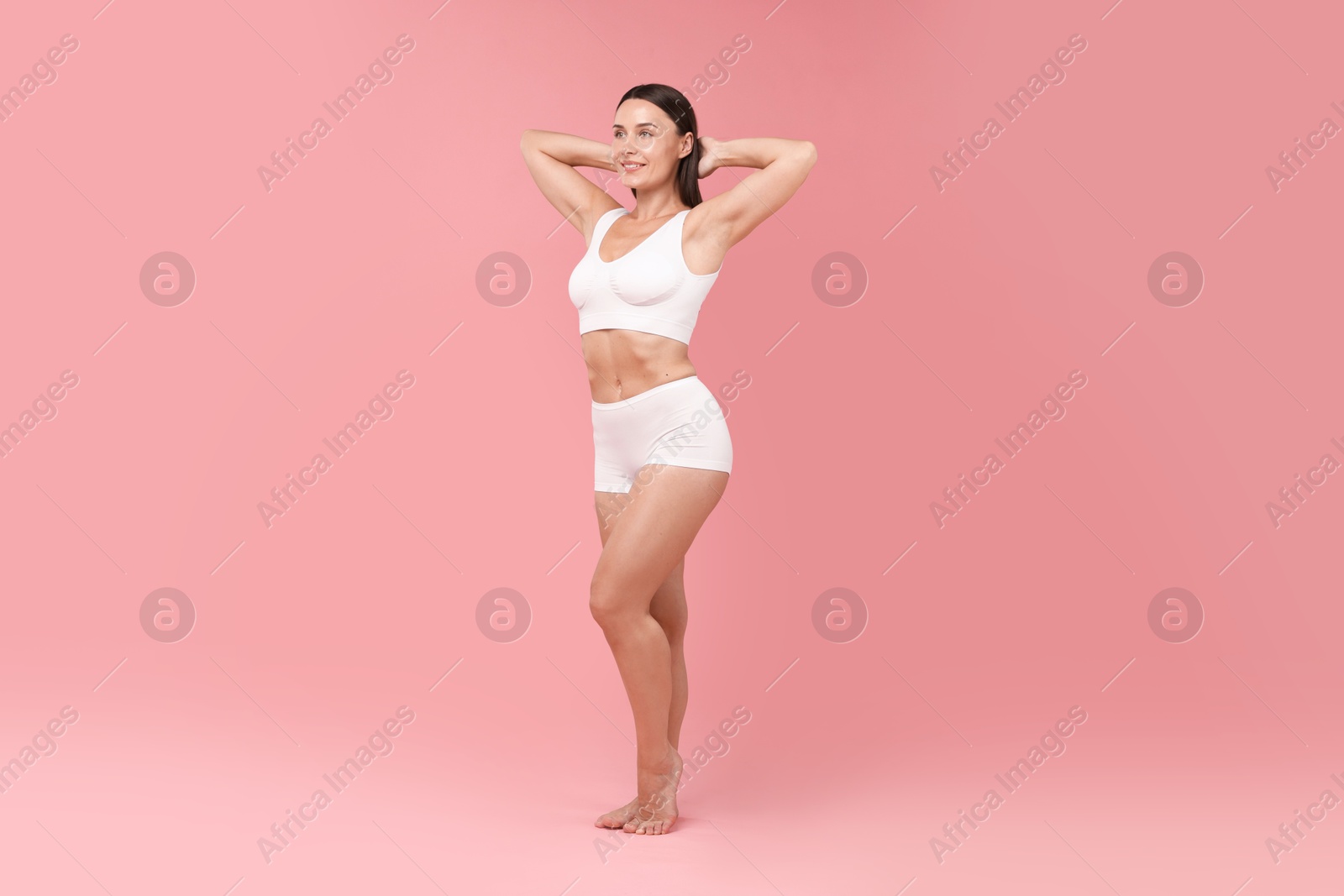 Photo of Fit woman with perfect body on pink background