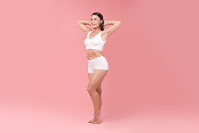 Photo of Fit woman with perfect body on pink background
