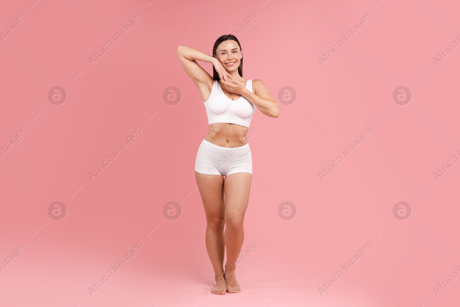 Photo of Fit woman with perfect body on pink background