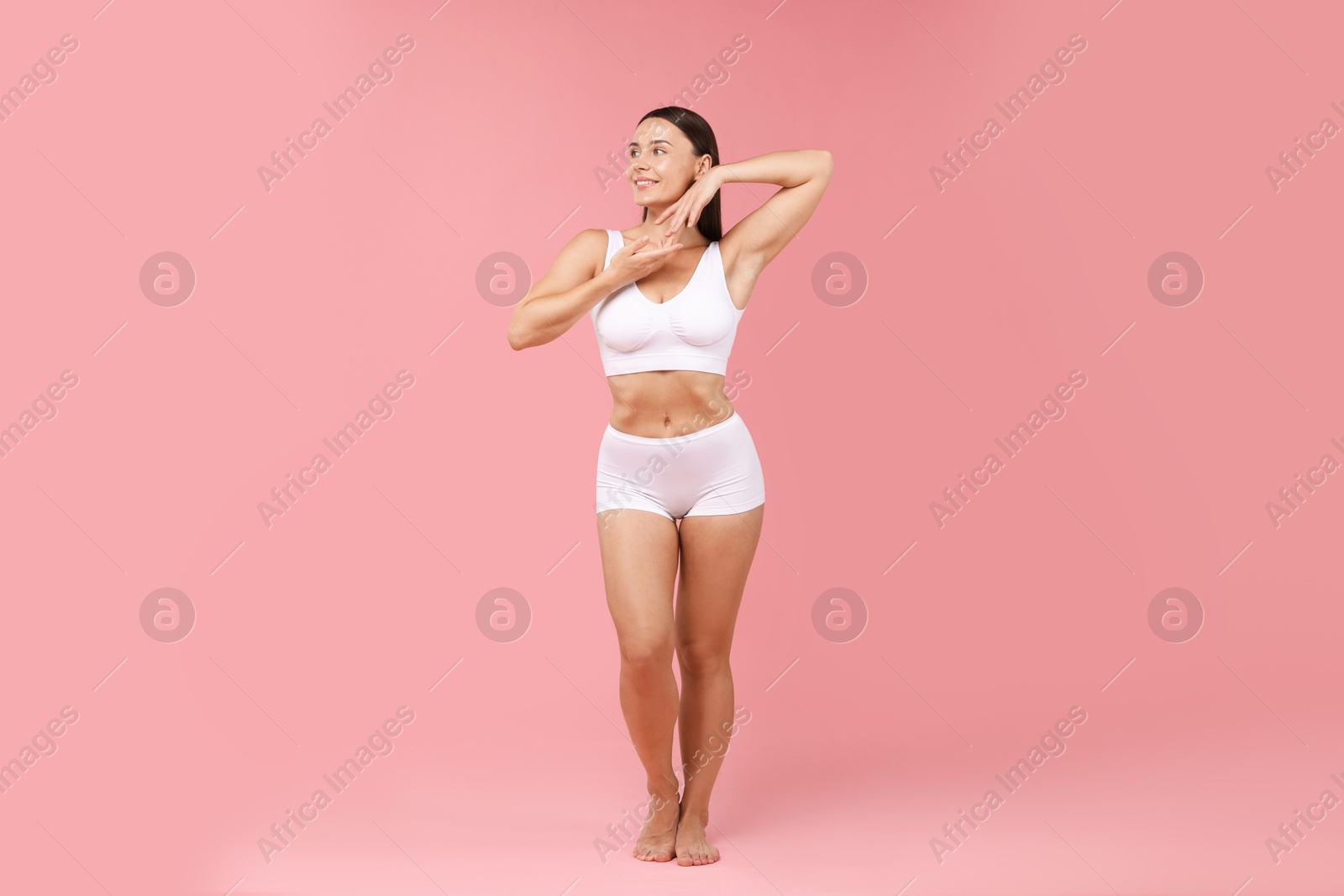 Photo of Fit woman with perfect body on pink background