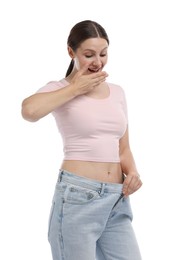Photo of Beautiful woman wearing old jeans after weight loss on white background