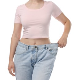 Photo of Woman wearing old jeans after weight loss on white background, closeup