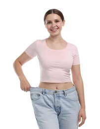 Photo of Beautiful woman wearing old jeans after weight loss on white background