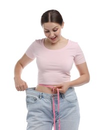 Photo of Beautiful woman with measuring tape wearing old jeans after weight loss on white background