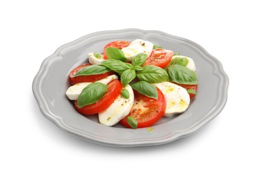 Photo of Tasty salad Caprese with mozzarella, tomatoes, basil and spices isolated on white