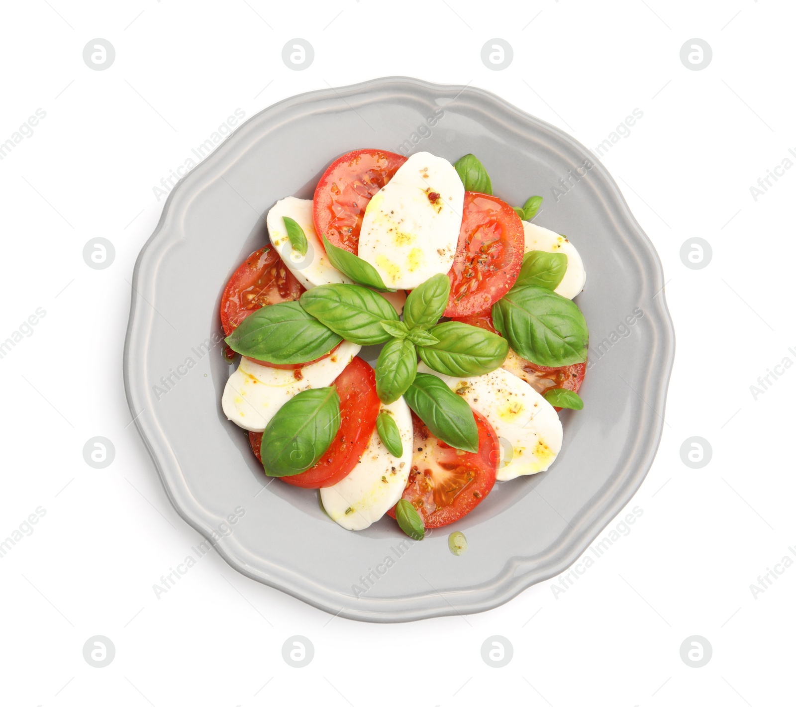 Photo of Tasty salad Caprese with mozzarella, tomatoes, basil and spices isolated on white, top view