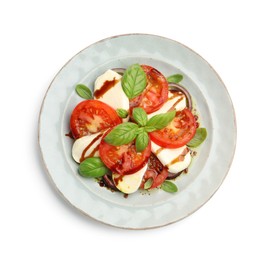 Photo of Tasty salad Caprese with mozzarella, tomatoes, basil and spices isolated on white, top view