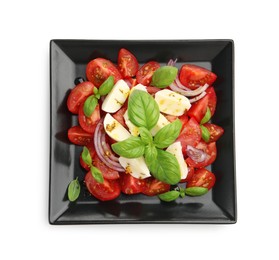 Photo of Tasty salad Caprese with mozzarella, tomatoes, basil, onion and spices isolated on white, top view