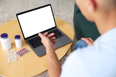 Photo of Man having online consultation with doctor via laptop at home, above view