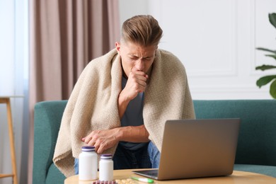 Photo of Sick man having online consultation with doctor via laptop at home
