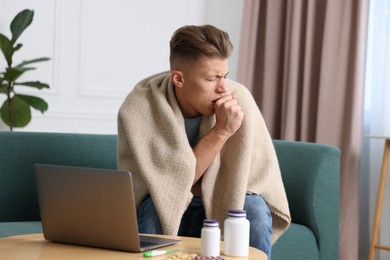 Photo of Sick man having online consultation with doctor via laptop at home