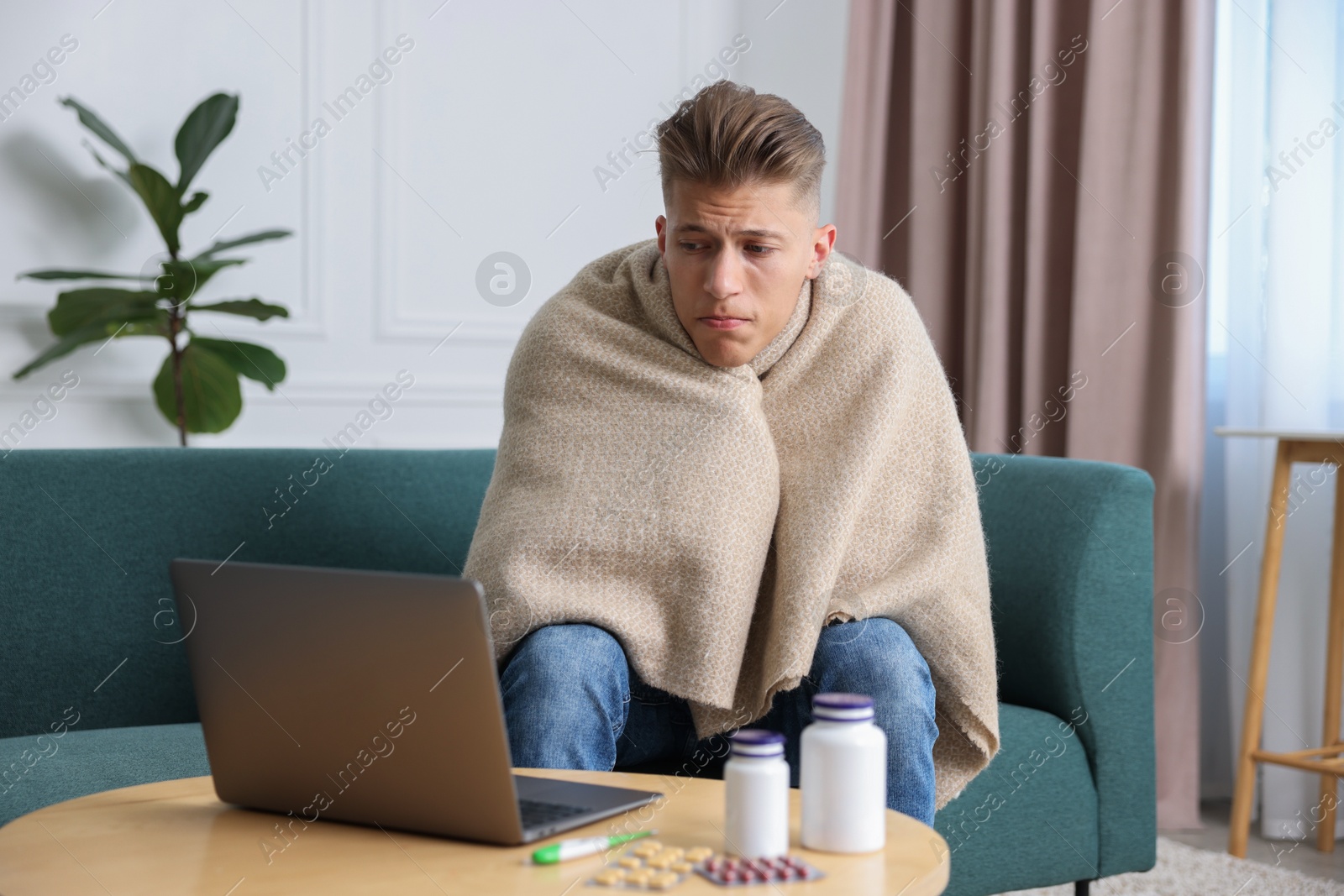 Photo of Sick man having online consultation with doctor via laptop at home