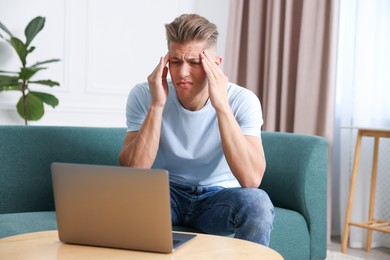 Photo of Sick man having online consultation with doctor via laptop at home