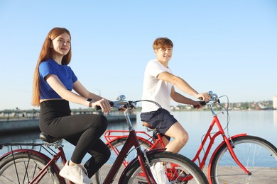 Photo of Teenage girl and boy riding bicycles outdoors