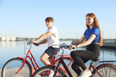 Photo of Teenage girl and boy riding bicycles outdoors