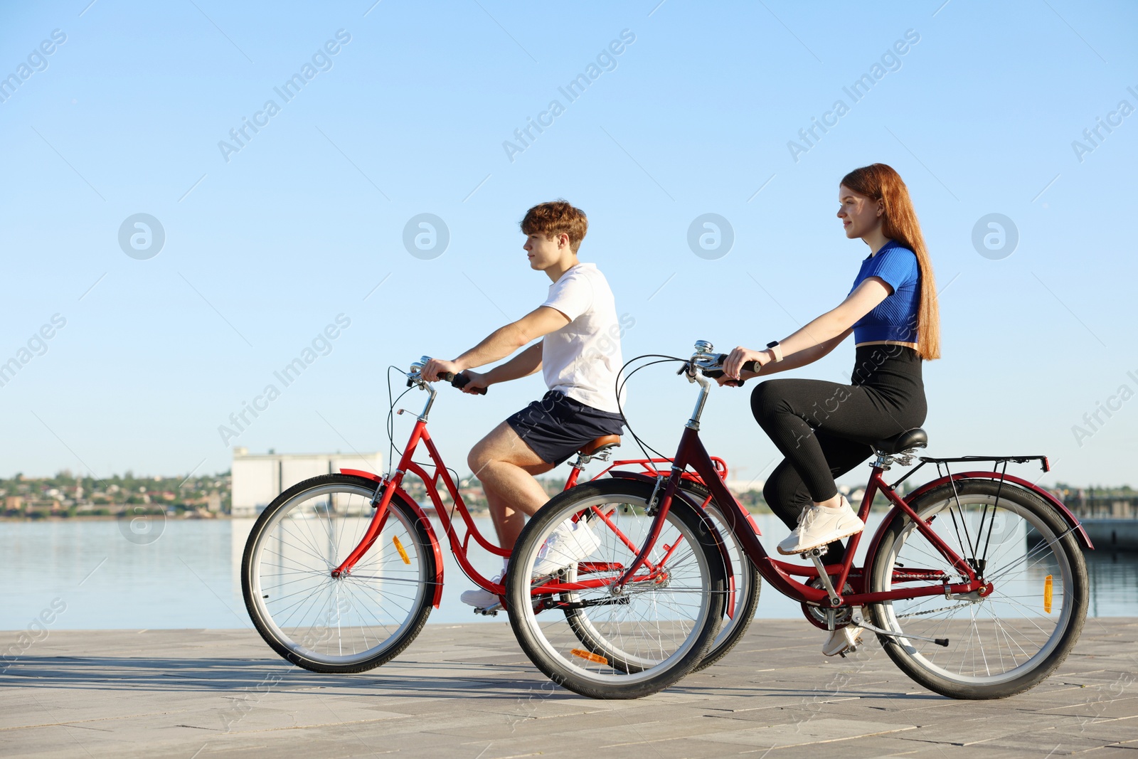 Photo of Teenage girl and boy riding bicycles outdoors