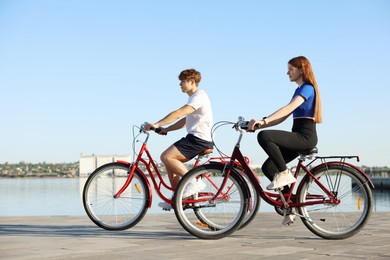Photo of Teenage girl and boy riding bicycles outdoors