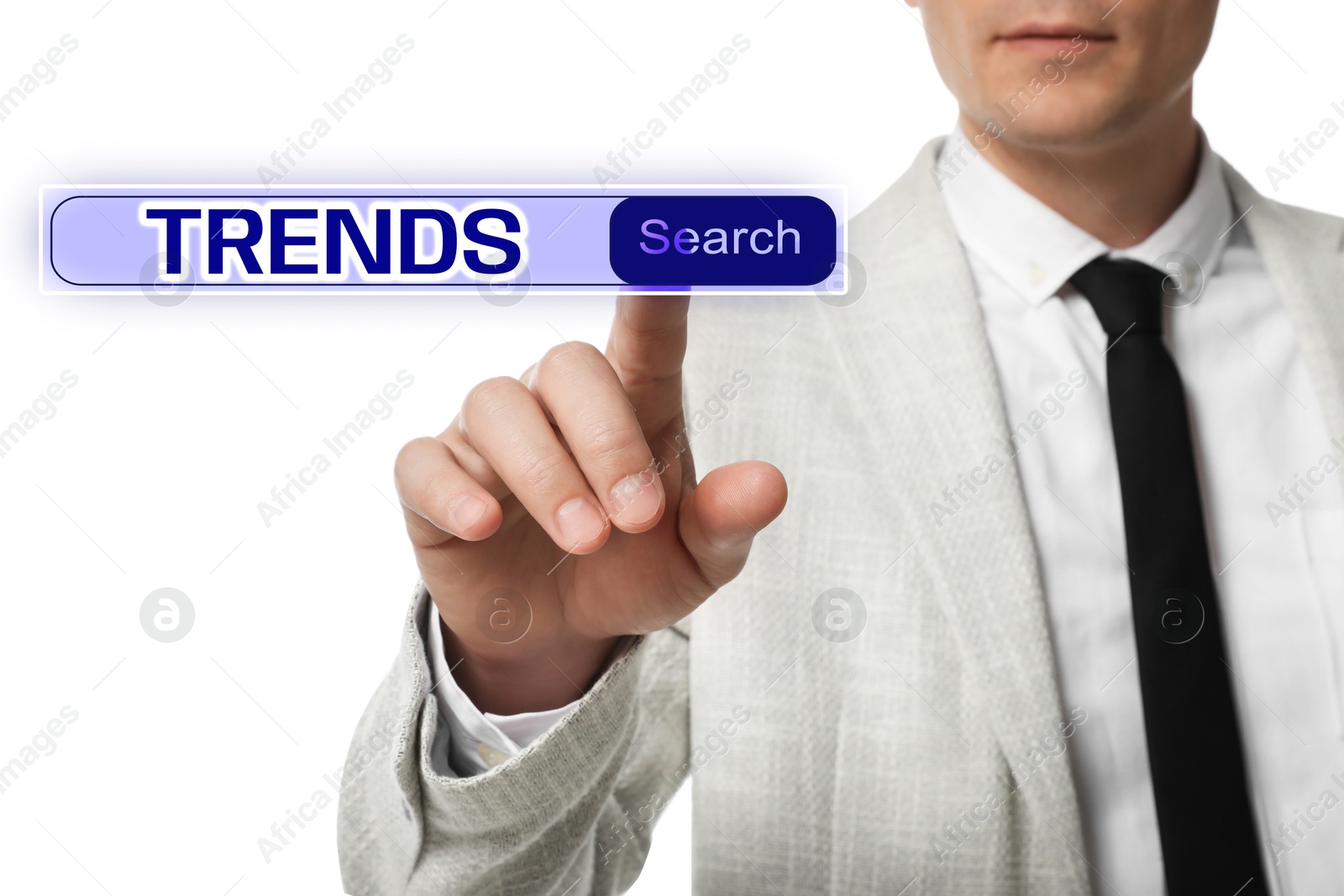 Image of Businessman using virtual screen to find hot tendencies, new ideas, popular directions against white background, closeup. Search bar with word Trends