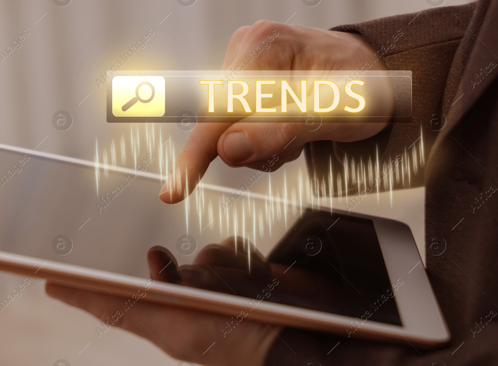 Businessman using tablet computer to find hot tendencies, new ideas, popular directions, closeup. Search bar with word Trends and graph Image of Businessman using tablet computer to find hot tendencies, new ideas, popular directions, closeup. Search bar with word Trends and graph
