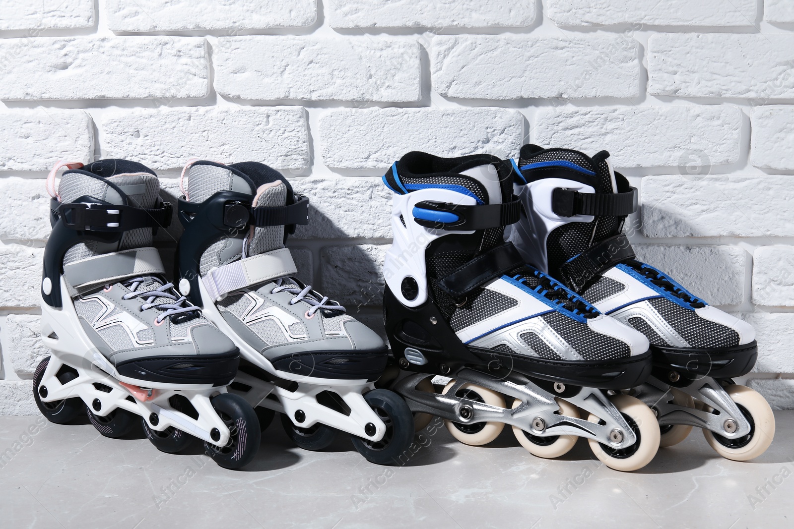 Photo of Roller skates on grey marble table near white brick wall