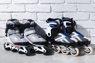 Photo of Roller skates on grey marble table near white brick wall