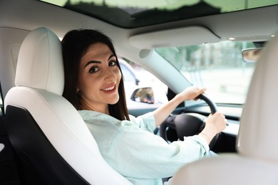 Photo of Woman holding steering wheel while driving car