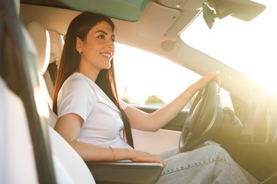 Photo of Woman behind steering wheel of modern car