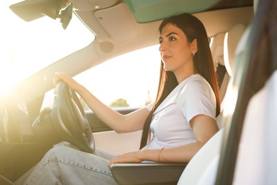 Photo of Woman behind steering wheel of modern car