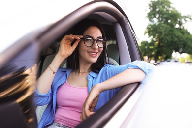 Photo of Woman in modern car, view from outside