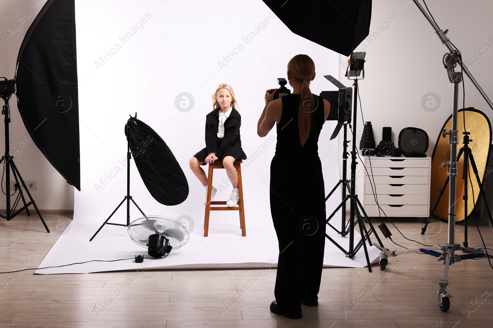Photographer working with model in professional photo studio Photo of Photographer working with model in professional photo studio