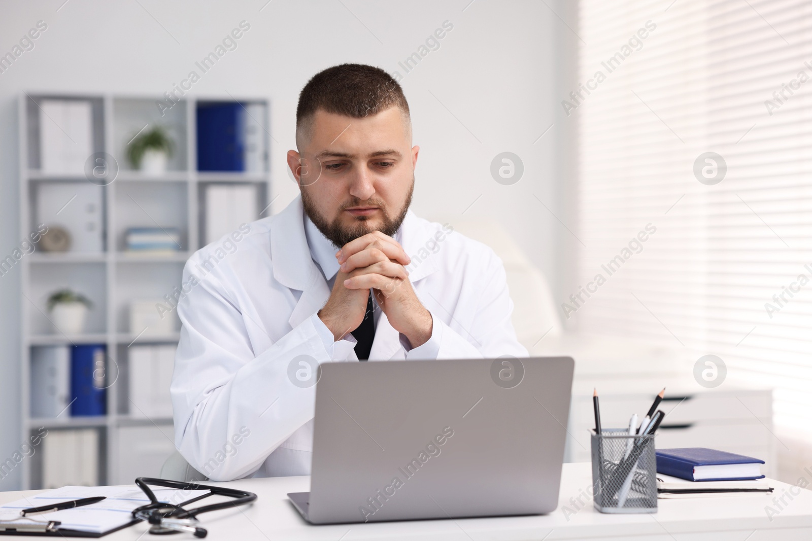Photo of Doctor having online consultation via laptop in clinic