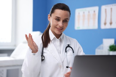 Photo of Doctor having online consultation via laptop in clinic