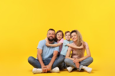 Photo of Happy family on yellow background. Space for text